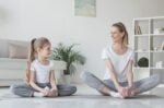mother and daughter practicing yoga in butterfly pose at home, ThePoemStory - Poems and Stories, Poems and Stories